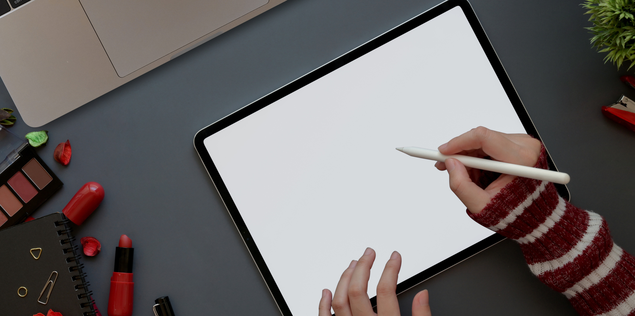 Faceless artist drawing on digitizing tablet with empty screen indoors